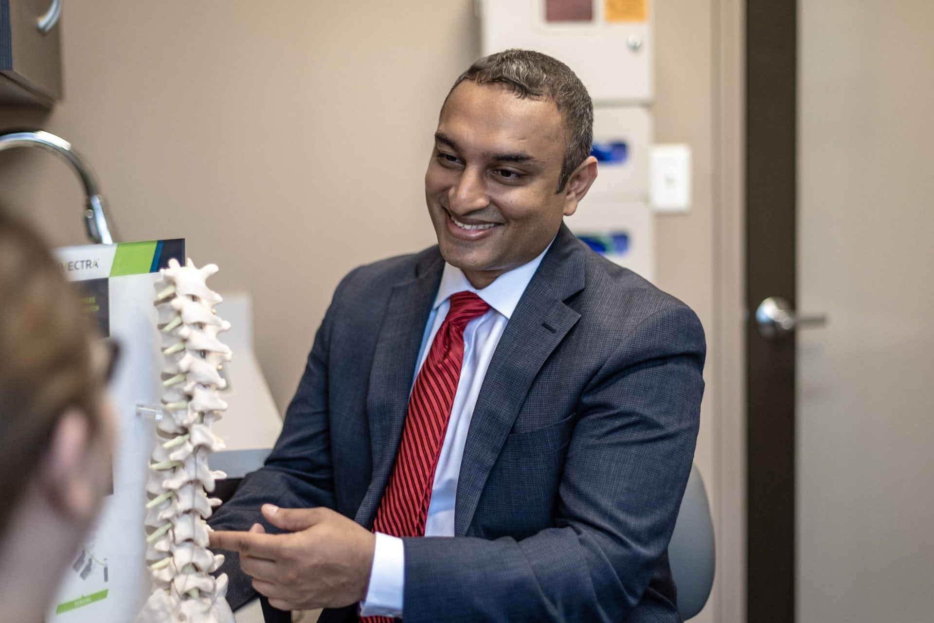 A man in a suit holding a spine